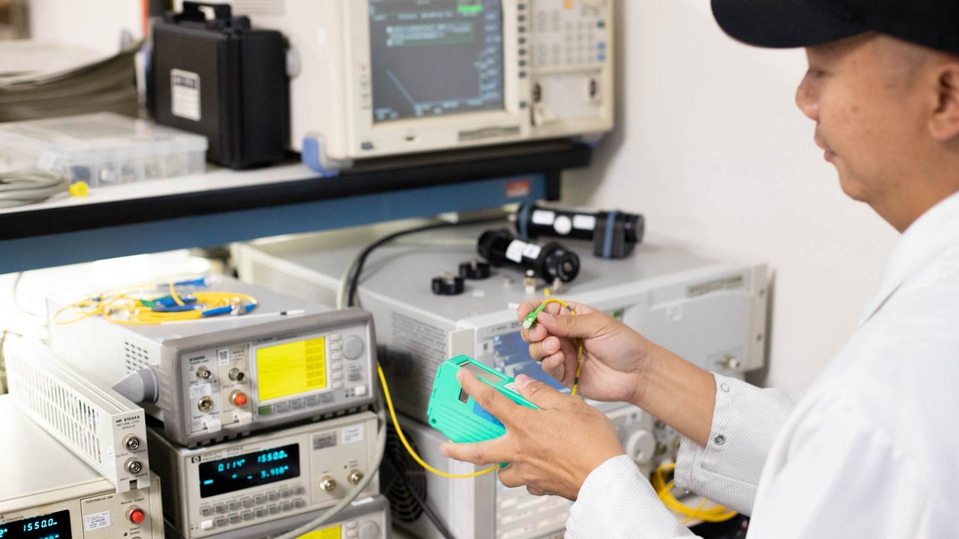 Lab technician testing fiber optic instruments