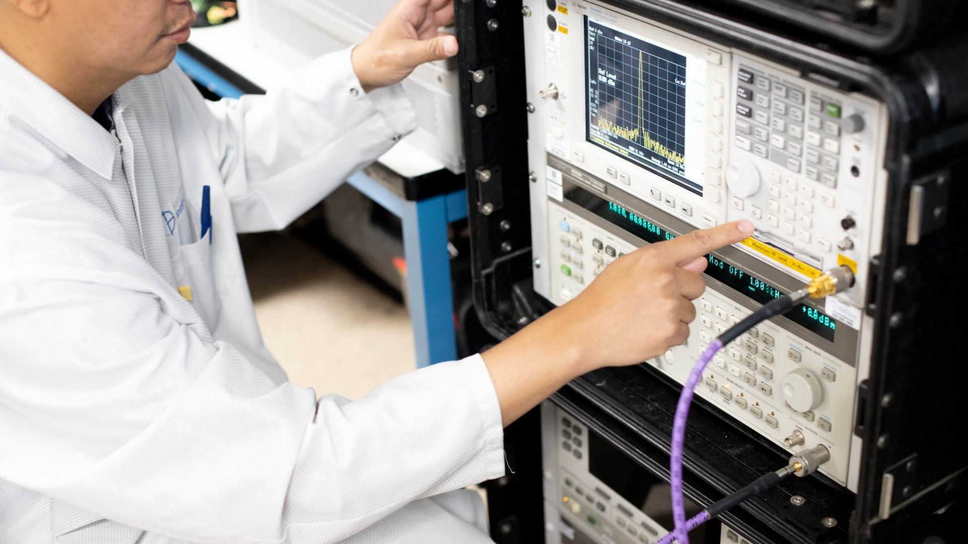 Lab technician using RF & Microwave calibration equipment