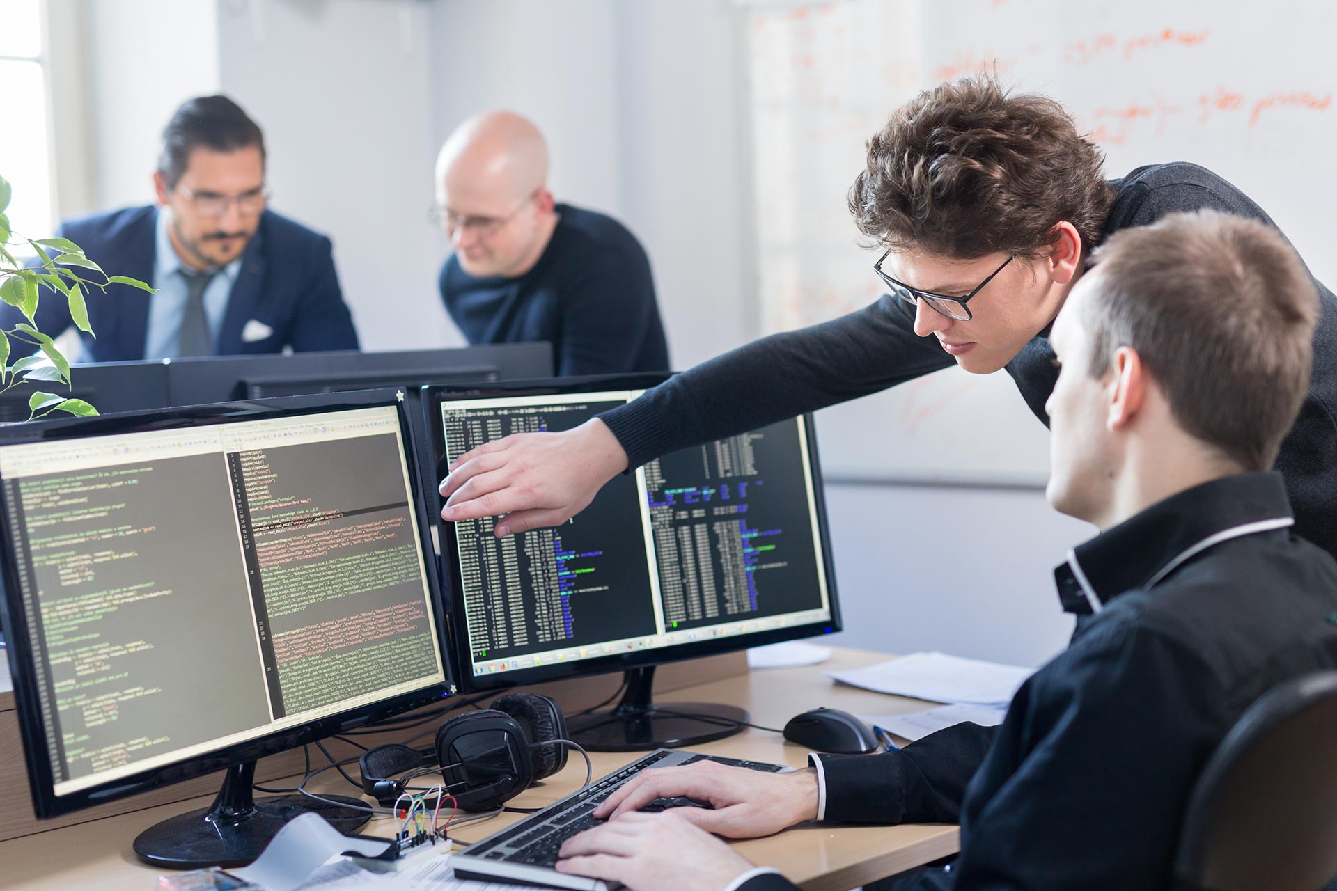 Software developer reviewing code with colleague